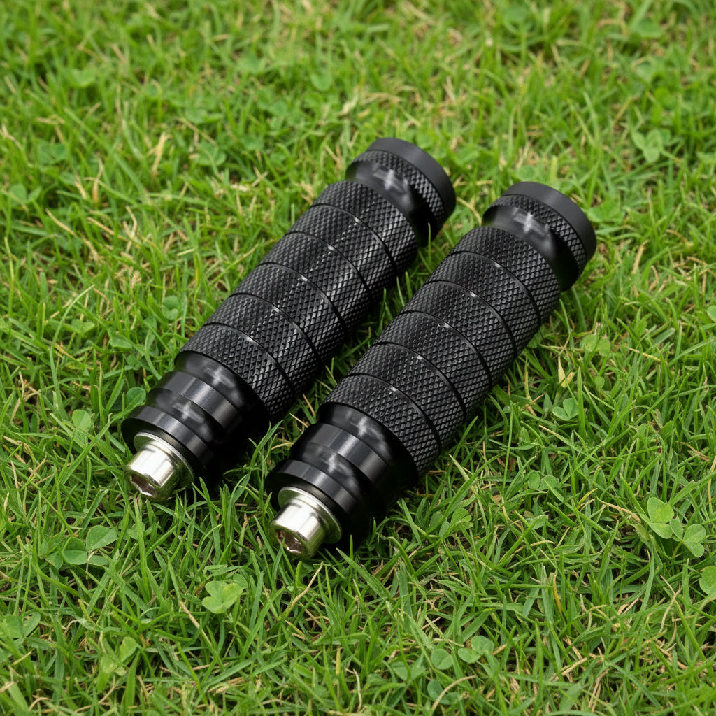 Two black motorcycle grips with gold connectors on a gradient background